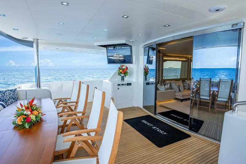 Slide: The Image of Luxurious Horizon RP120 yacht interior with ocean view, featuring elegant seating and floral arrangements. - 11