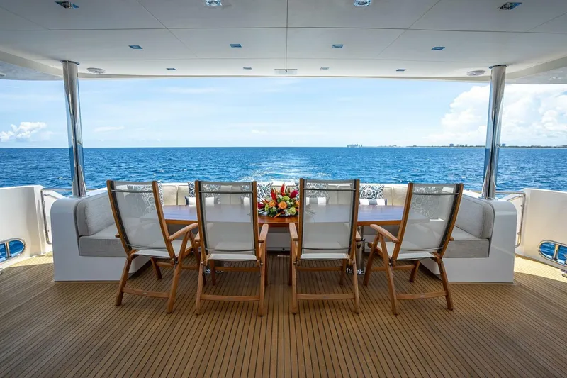 Slide: The Image of Luxury yacht deck with dining area, Horizon RP120, 2017, overlooking the ocean. - 12