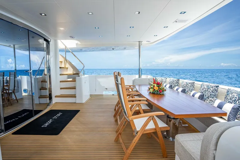 Slide: The Image of Luxurious Horizon RP120 yacht deck with elegant dining area, ocean view, and stylish seating, 2017 model. - 13