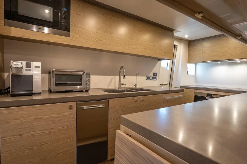 Slide: The Image of Modern kitchen in 2017 Horizon RP120 yacht with appliances and sleek wooden cabinetry. - 20