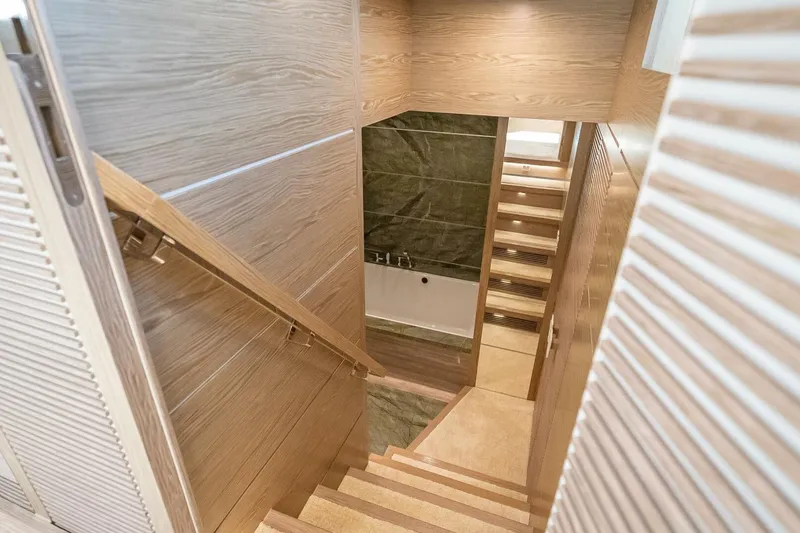 Slide: The Image of Wooden staircase leading to a modern bathroom in a 2017 Horizon RP120 yacht. - 34