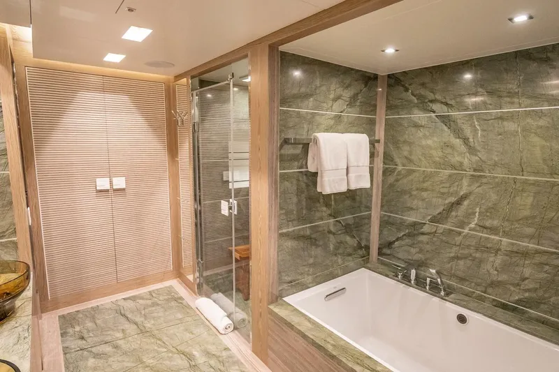Slide: The Image of Luxurious bathroom with marble tiles, glass shower, and bathtub in Horizon RP120 yacht, 2017. - 37