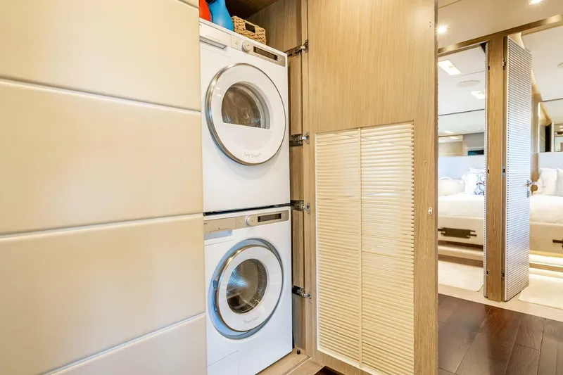 Slide: The Image of Stacked washer and dryer in a modern laundry area on a 2017 Horizon RP120 yacht. - 44