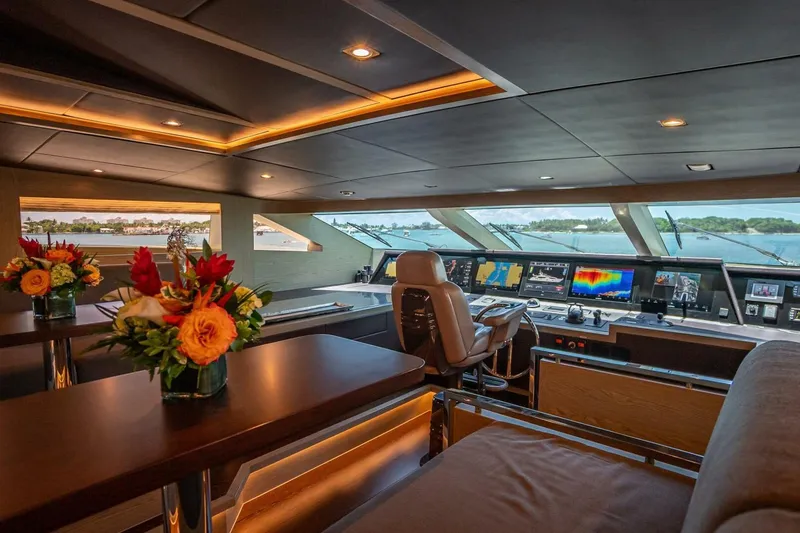 Slide: The Image of Luxurious Horizon RP120 yacht interior with modern navigation equipment and elegant floral arrangements, 2017 model. - 54