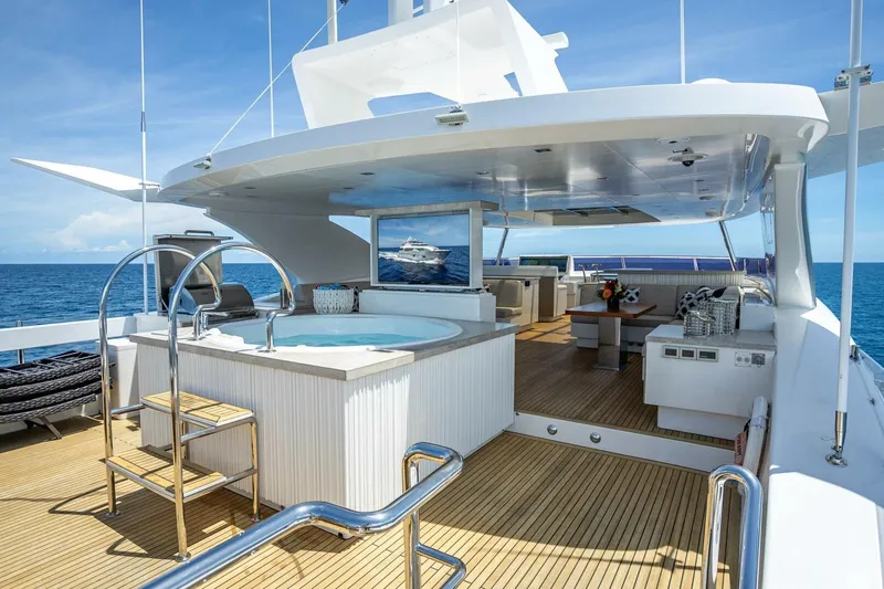 Slide: The Image of Luxurious Horizon RP120 yacht deck with jacuzzi, seating area, and ocean view, 2017 model. - 59