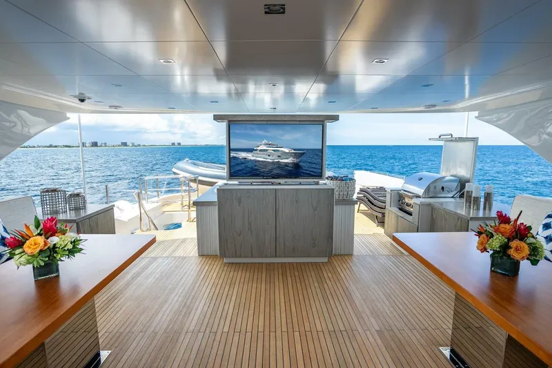 Slide: The Image of Luxurious Horizon RP120 yacht deck with ocean view, featuring elegant seating and vibrant floral arrangements. - 65