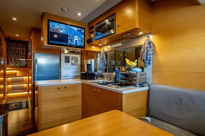 Slide: The Image of Luxurious kitchen interior of 2017 Horizon RP120 yacht with modern appliances and wood finish. - 76