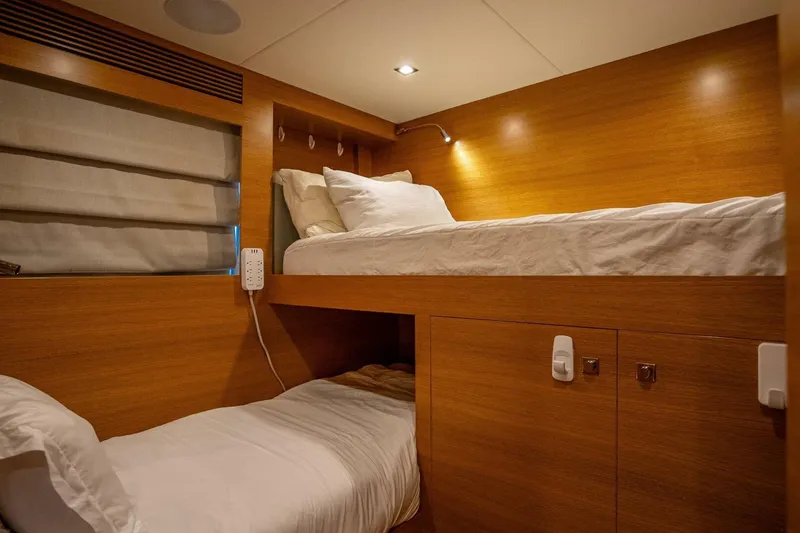 Slide: The Image of Bunk beds in a 2017 Horizon RP120 yacht cabin with wooden interior. - 80