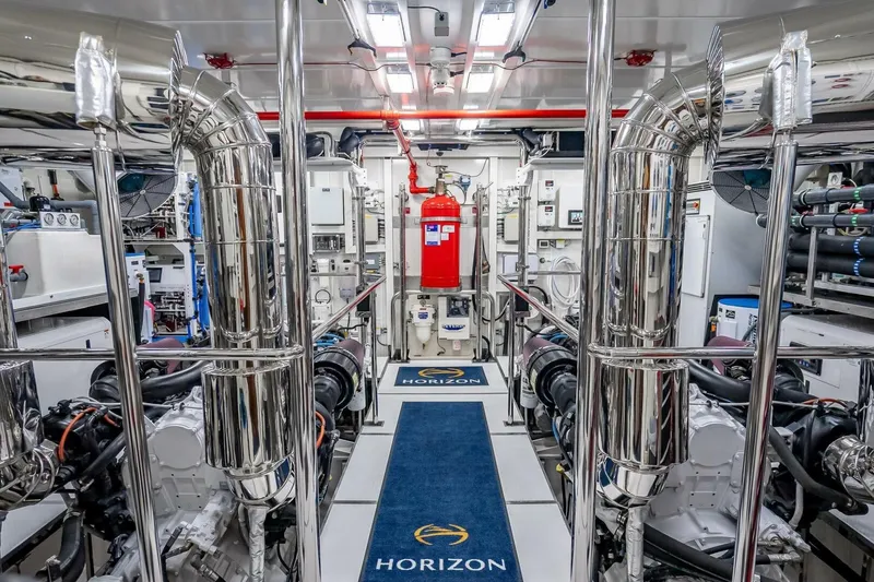 Slide: The Image of Engine room of 2017 Horizon RP120 yacht with polished metal pipes and equipment. - 81