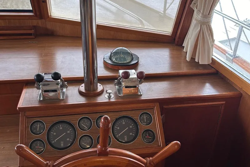 Slide: The Image of Helm of 1985 Grand Banks 42 Classic with gauges and compass. - 10