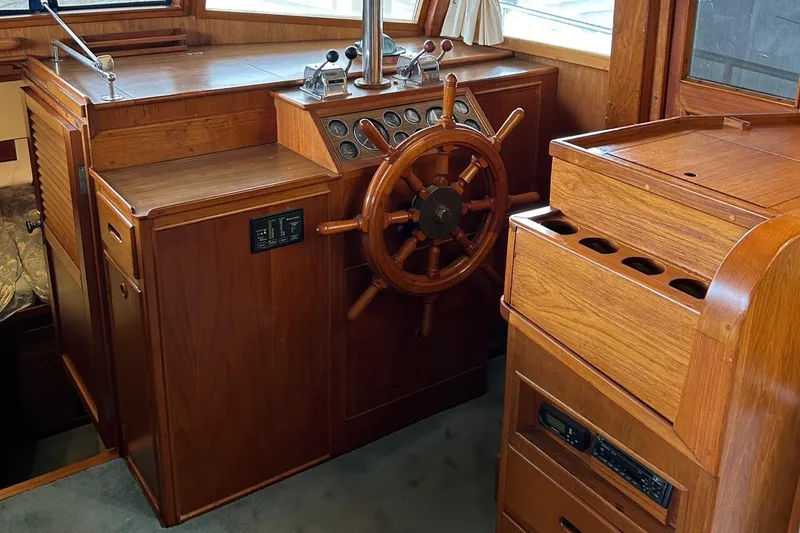 Slide: The Image of 1985 Grand Banks 42 Classic helm with wooden wheel and control panel. - 11