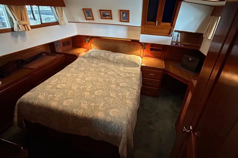 Slide: The Image of Cozy bedroom interior of 1985 Grand Banks 42 Classic yacht with wood furnishings. - 13