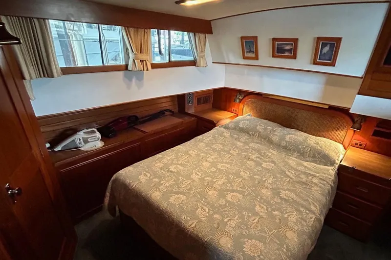 Slide: The Image of Cozy bedroom in 1985 Grand Banks 42 Classic yacht with wood accents and nautical decor. - 17