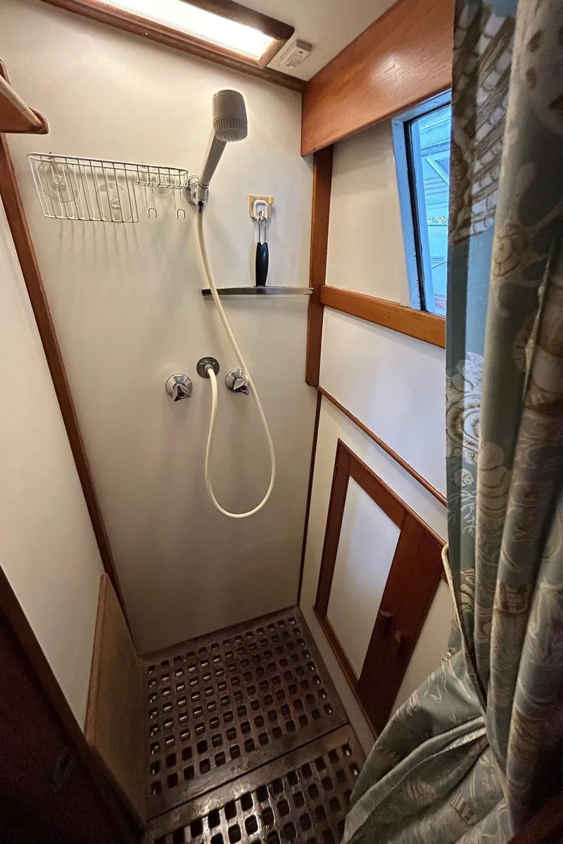 Slide: The Image of 1985 Grand Banks 42 Classic yacht shower with wooden accents and nautical design. - 19