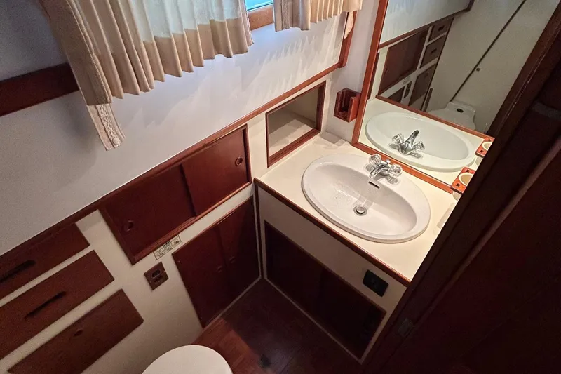 Slide: The Image of Bathroom interior of 1985 Grand Banks 42 Classic yacht with sink and wooden cabinetry. - 20