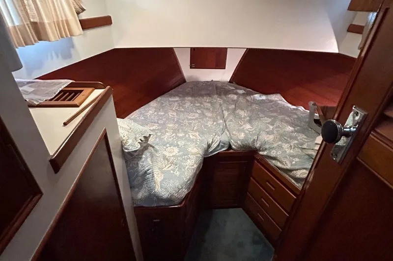 Slide: The Image of Cozy cabin interior of 1985 Grand Banks 42 Classic with wood paneling and patterned bedding. - 21