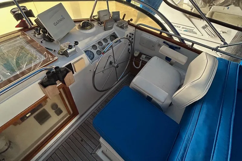Slide: The Image of Cockpit of 1985 Grand Banks 42 Classic with navigation equipment and blue seating. - 26