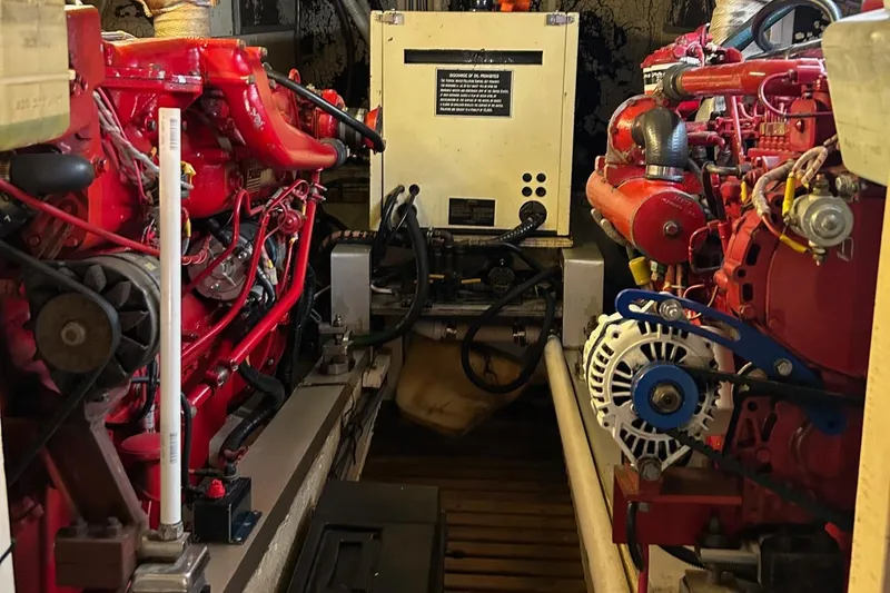 Slide: The Image of Engine room of a 1985 Grand Banks 42 Classic with red machinery and equipment. - 35