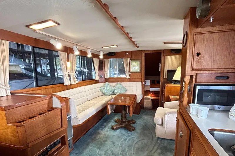 Slide: The Image of Interior of 1985 Grand Banks 42 Classic yacht with cozy seating and wooden finishes. - 6