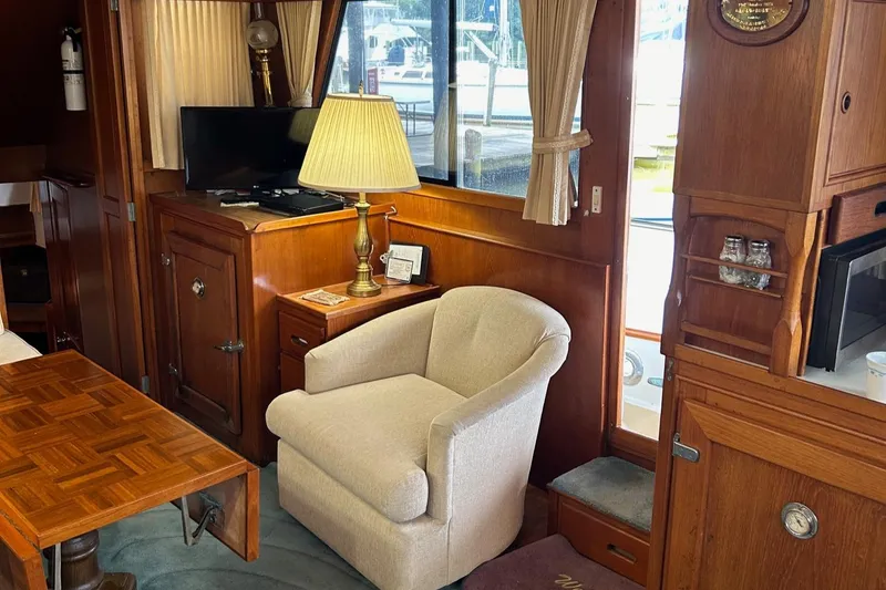 Slide: The Image of Interior of 1985 Grand Banks 42 Classic yacht with cozy seating and wooden furnishings. - 8