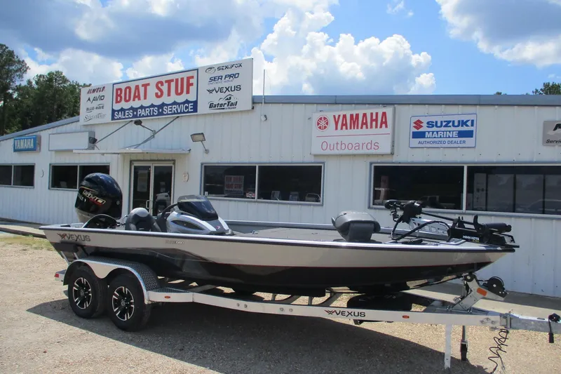 The Image of 2026 Vexus AVX1980 boat on trailer outside dealership with Yamaha and Suzuki signage. - 0