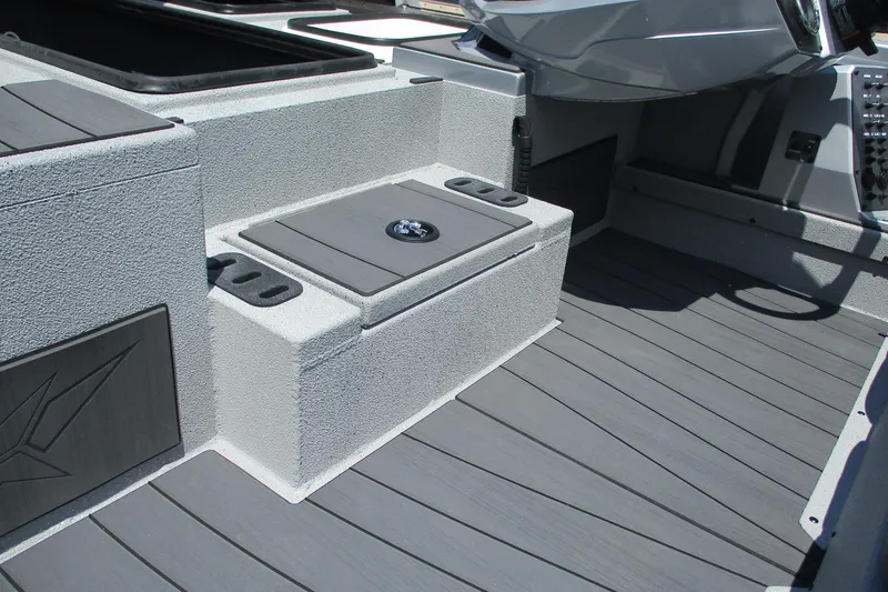 Slide: The Image of 2026 Vexus AVX1980 boat interior with gray textured flooring and storage compartments. - 14
