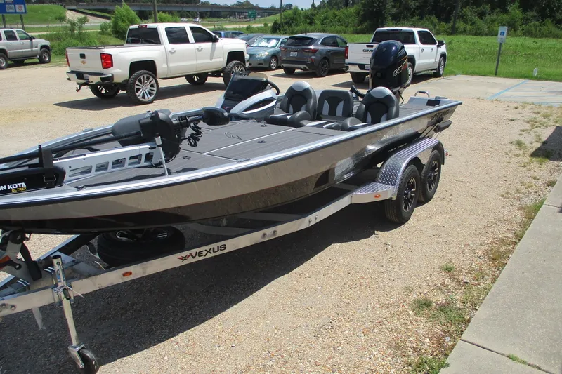 Slide: The Image of 2026 Vexus AVX1980 boat on trailer in parking lot, surrounded by vehicles. - 6