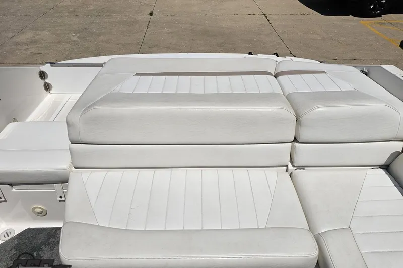 Slide: The Image of 2007 Regal 2000 Bowrider boat with white cushioned seating on deck. - 104