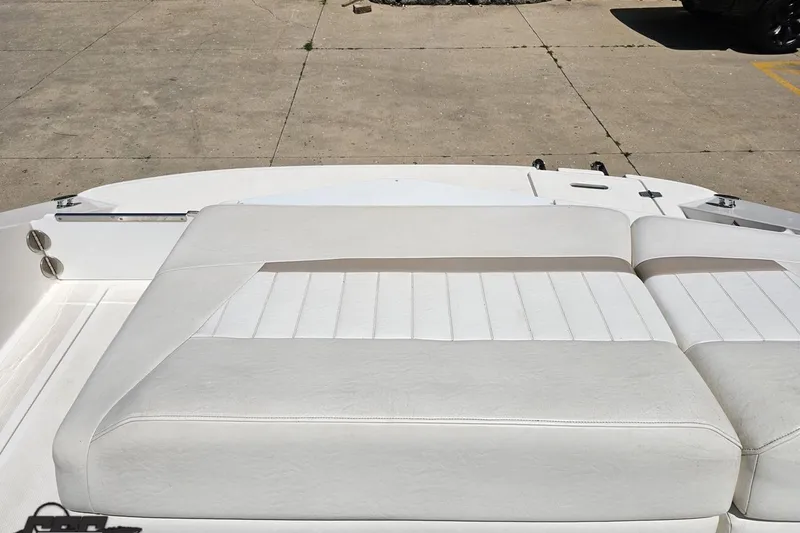 Slide: The Image of 2007 Regal 2000 Bowrider boat with white cushioned seating on concrete surface. - 105