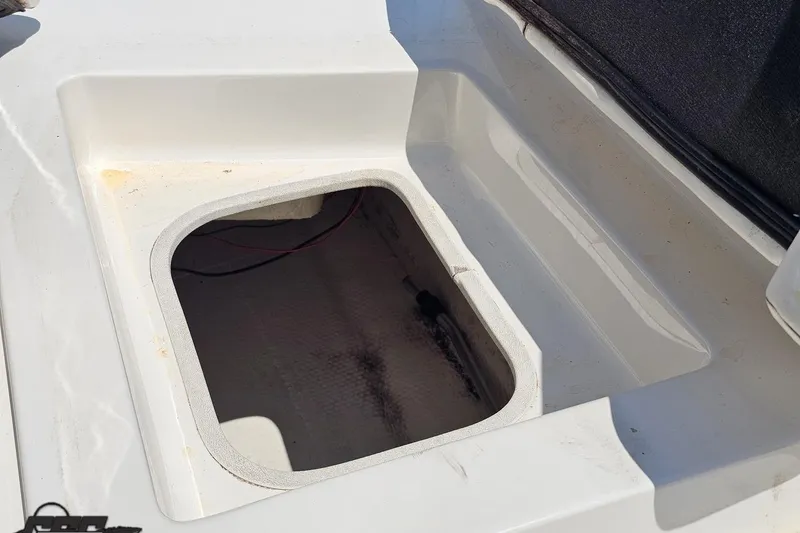 Slide: The Image of 2007 Regal 2000 Bowrider storage compartment, open and empty, with visible wiring. - 107