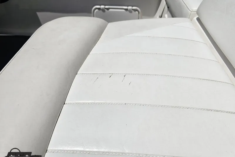 Slide: The Image of White leather seat with slight wear on a 2007 Regal 2000 Bowrider boat. - 109