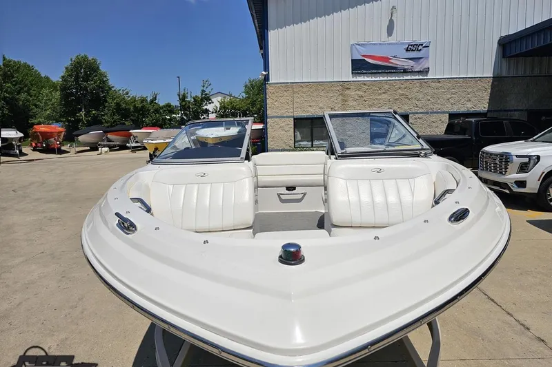 Slide: The Image of 2007 Regal 2000 Bowrider boat with white seating, parked outdoors. - 11