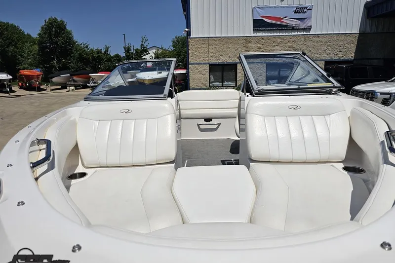 Slide: The Image of 2007 Regal 2000 Bowrider boat with white interior seating, parked outdoors. - 12