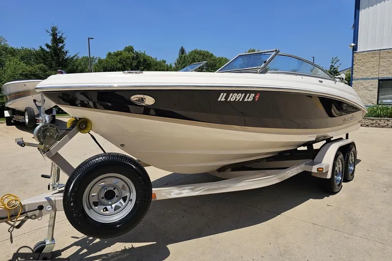 Slide: The Image of 2007 Regal 2000 Bowrider boat on trailer, parked outdoors on a sunny day. - 14