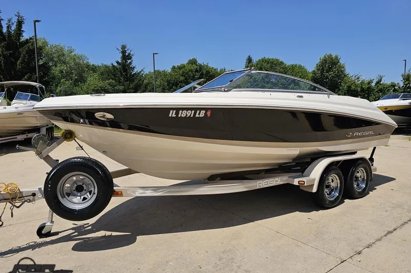 Slide: The Image of 2007 Regal 2000 Bowrider boat on trailer, parked outdoors on a sunny day. - 15