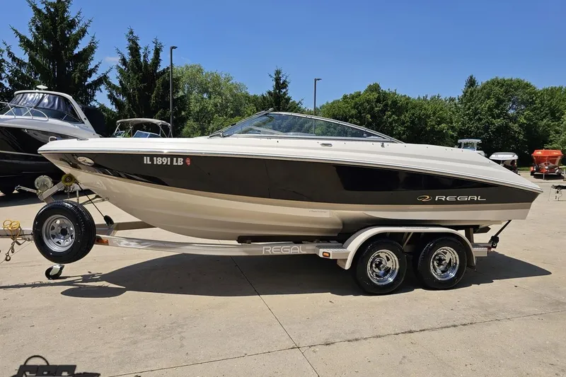 Slide: The Image of 2007 Regal 2000 Bowrider boat on trailer, parked outdoors on a sunny day. - 16