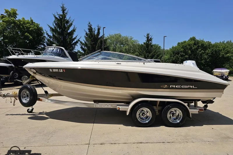 Slide: The Image of 2007 Regal 2000 Bowrider boat on trailer, parked outdoors on a sunny day. - 17