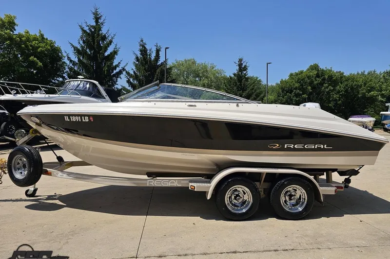 Slide: The Image of 2007 Regal 2000 Bowrider boat on trailer, parked outdoors on a sunny day. - 18
