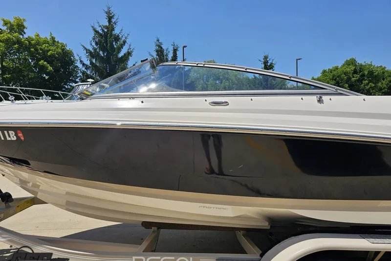 Slide: The Image of 2007 Regal 2000 Bowrider boat on trailer, sunny day, trees in background. - 20