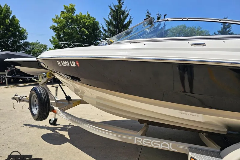 Slide: The Image of 2007 Regal 2000 Bowrider boat on trailer, parked outdoors, sunny day. - 21