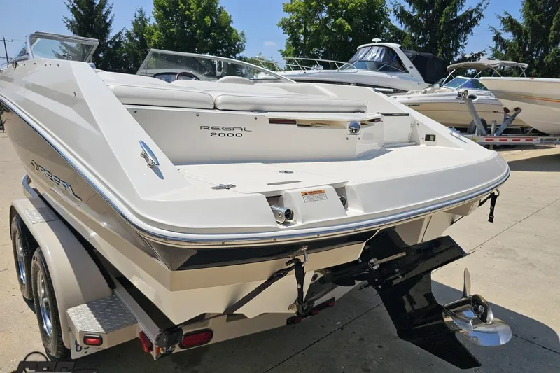 Slide: The Image of 2007 Regal 2000 Bowrider boat, white exterior, parked on a trailer, sunny day. - 27