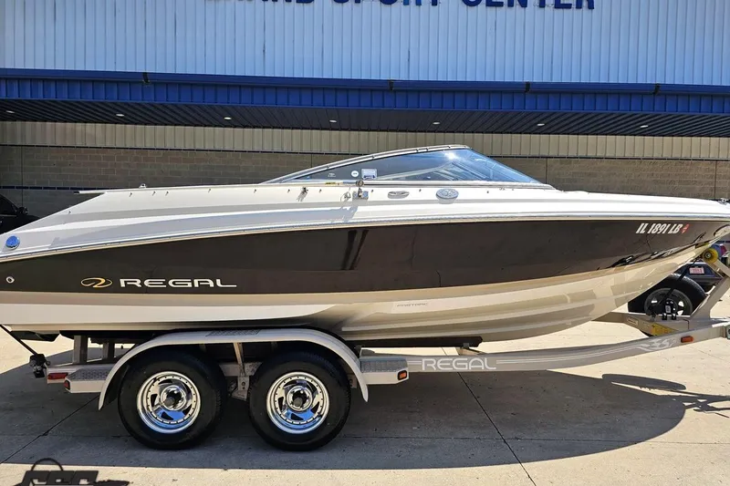 Slide: The Image of 2007 Regal 2000 Bowrider boat on trailer, parked outside a building. - 3
