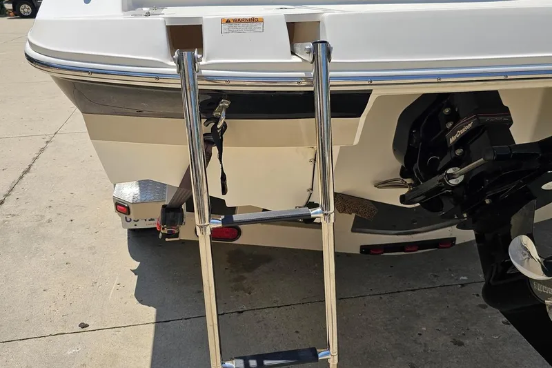 Slide: The Image of 2007 Regal 2000 Bowrider boat with ladder and MerCruiser engine. - 33