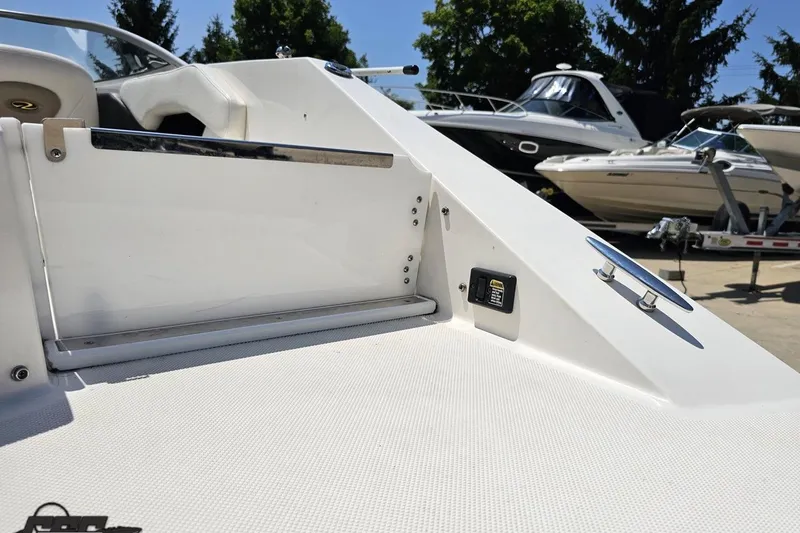 Slide: The Image of 2007 Regal 2000 Bowrider boat interior with seating and control panel, docked outdoors. - 37