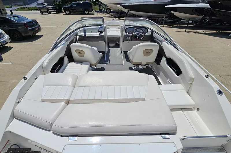 Slide: The Image of 2007 Regal 2000 Bowrider boat with white interior, parked outdoors. - 38