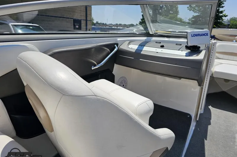 Slide: The Image of 2007 Regal 2000 Bowrider interior with white seating and Lowrance navigation system. - 49