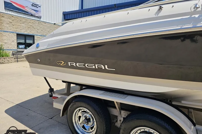 Slide: The Image of 2007 Regal 2000 Bowrider boat on trailer, parked outside a building. - 5