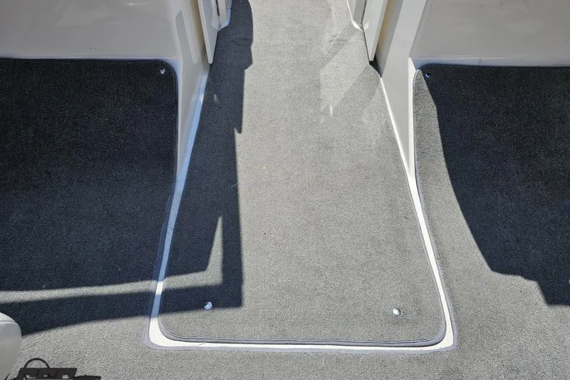 Slide: The Image of Interior view of 2007 Regal 2000 Bowrider boat with gray carpet flooring. - 52