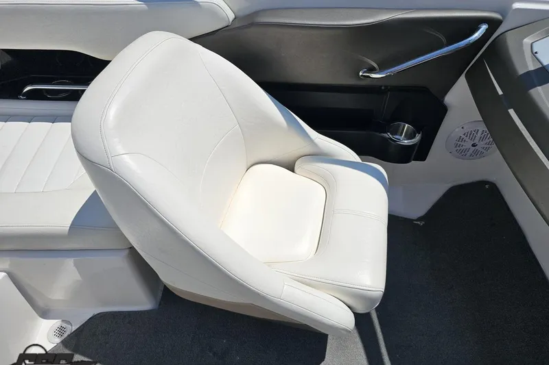 Slide: The Image of White leather seat in 2007 Regal 2000 Bowrider boat interior, featuring cup holder and speaker. - 54