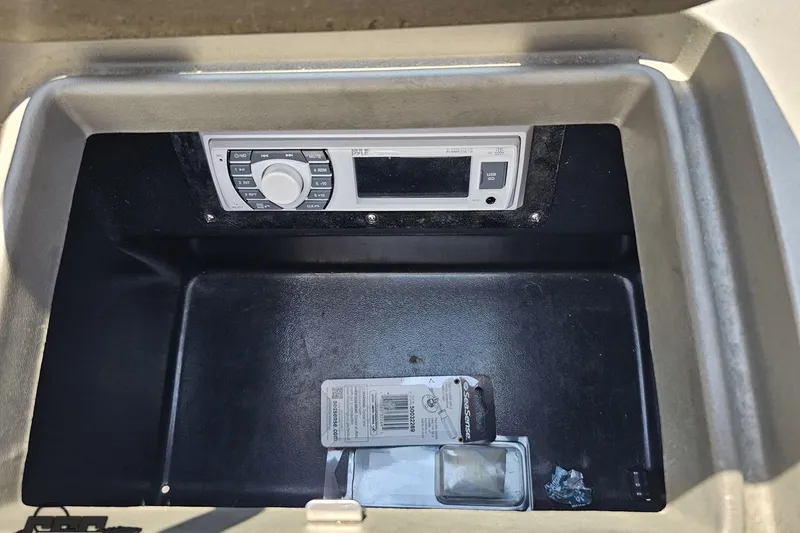 Slide: The Image of 2007 Regal 2000 Bowrider dashboard with stereo system and storage compartment. - 58